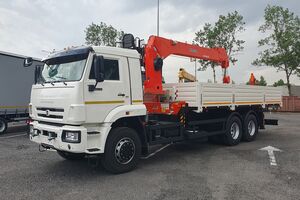 Бортовой КАМАЗ 65117-104020-49 с КМУ Kanglim 1256, задние раздвижные доп.опоры, платформа 6818